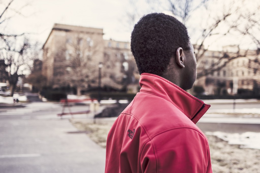 teenager at a park in the winter looking away from the camera